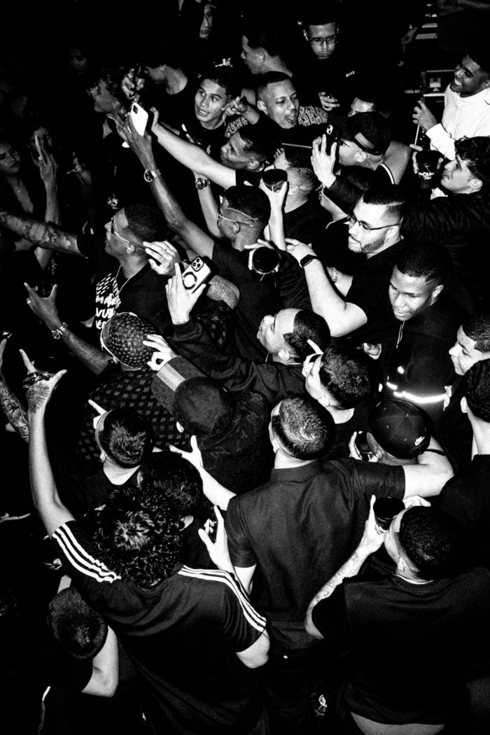 A vibrant hip-hop concert crowd captured in dynamic black and white photography.
